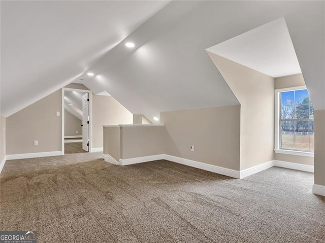 additional living space with lofted ceiling, baseboards, carpet flooring, and recessed lighting