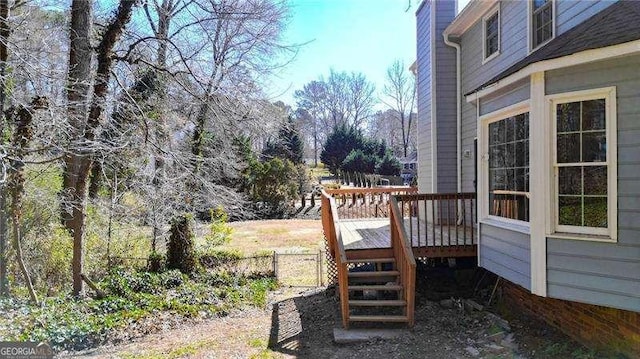 exterior space featuring fence and a deck