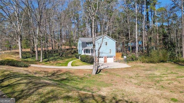 exterior space with an attached garage, driveway, and a front yard