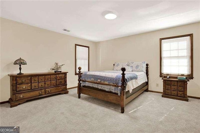 bedroom with carpet flooring, visible vents, and baseboards