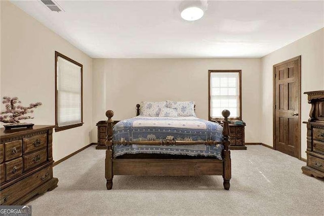 bedroom with carpet flooring, visible vents, and baseboards