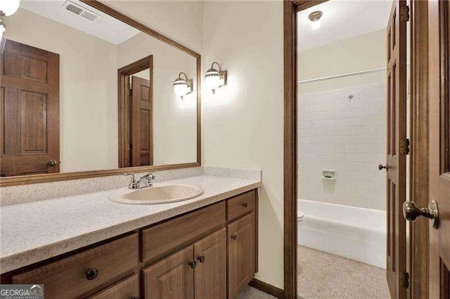 bathroom with toilet, shower / washtub combination, vanity, and visible vents