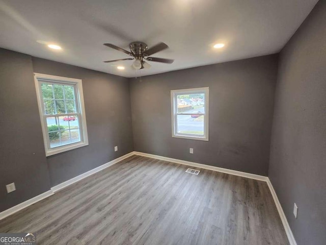 unfurnished room with baseboards, visible vents, a ceiling fan, wood finished floors, and recessed lighting