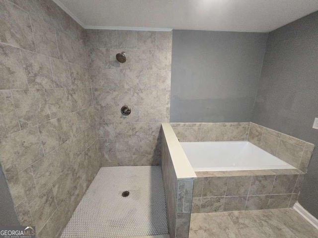 bathroom featuring tiled shower and a bath