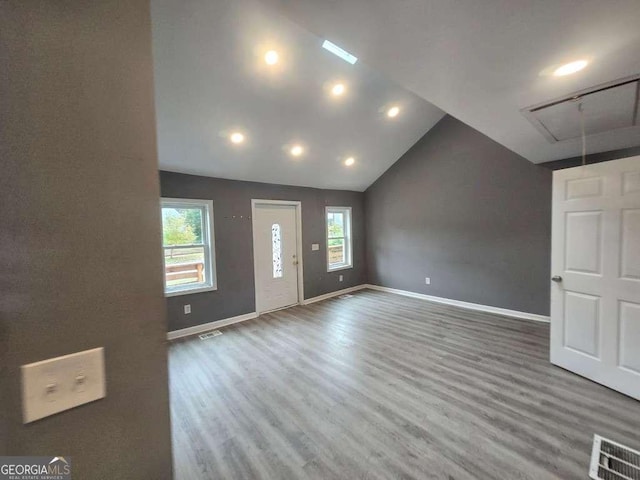 entryway with baseboards, visible vents, and wood finished floors