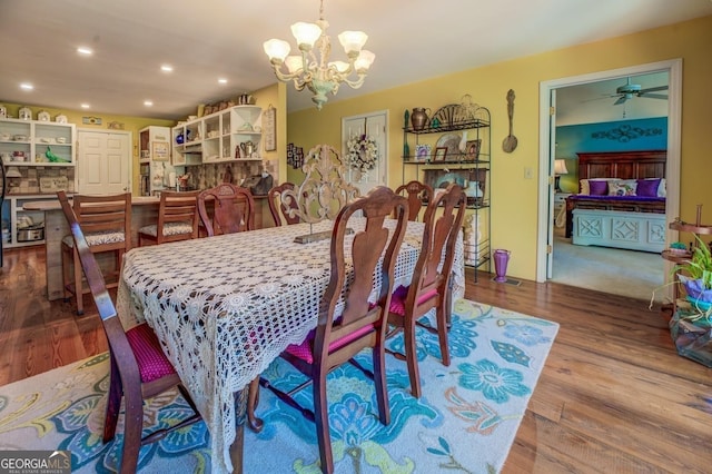 dining space with an inviting chandelier, wood finished floors, and recessed lighting