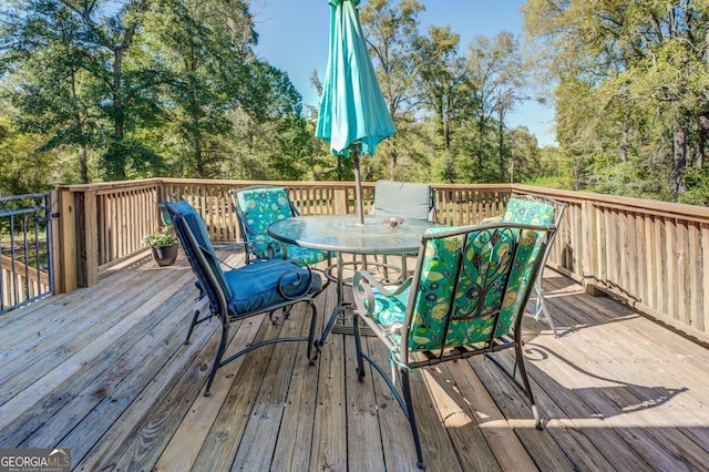 wooden deck featuring outdoor dining space