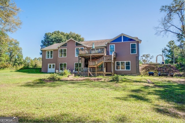 rear view of property with a yard, a deck, and stairs