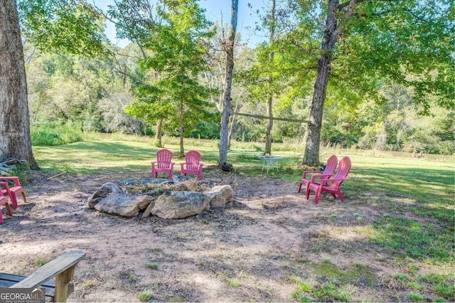 view of yard featuring an outdoor fire pit