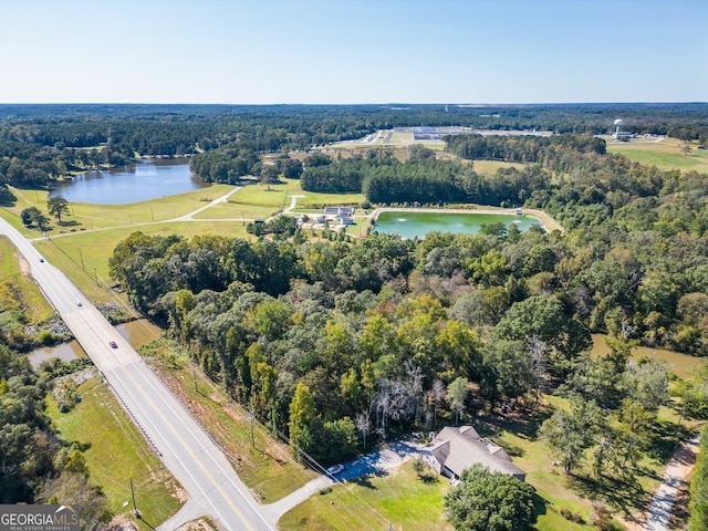 aerial view with a forest view and a water view