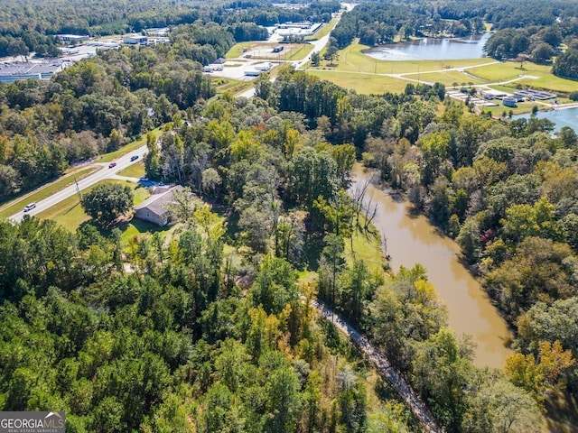 aerial view with a water view and a view of trees