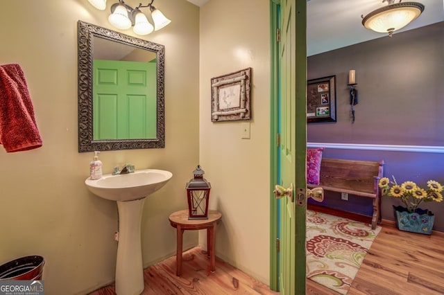 bathroom with a sink and wood finished floors