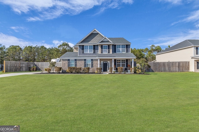 view of front facade featuring fence and a front yard