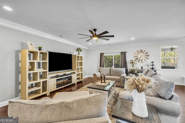 living room featuring ornamental molding, a wealth of natural light, and dark wood-style floors