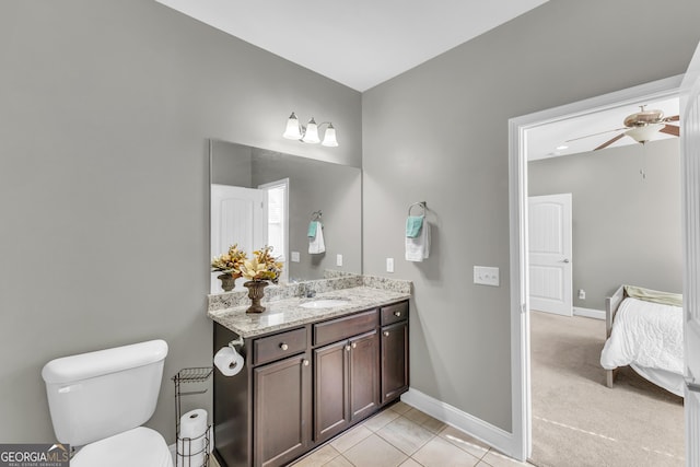 bathroom featuring baseboards, toilet, ceiling fan, tile patterned floors, and vanity