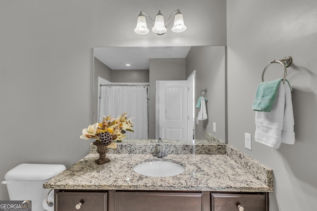 full bath featuring toilet and vanity