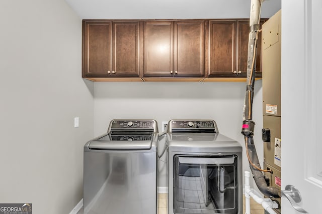 laundry area featuring cabinet space and washing machine and clothes dryer