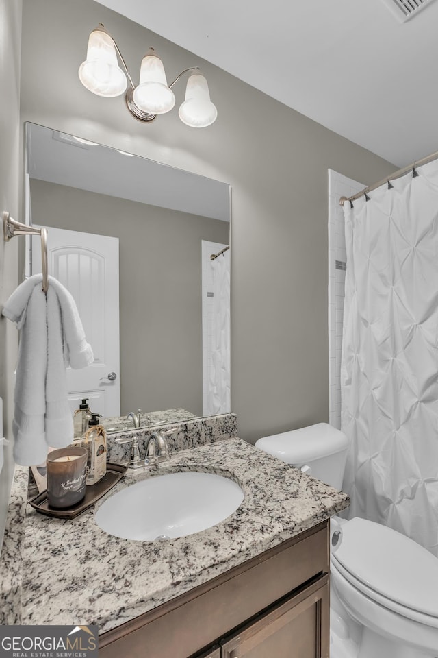 bathroom featuring vanity and toilet