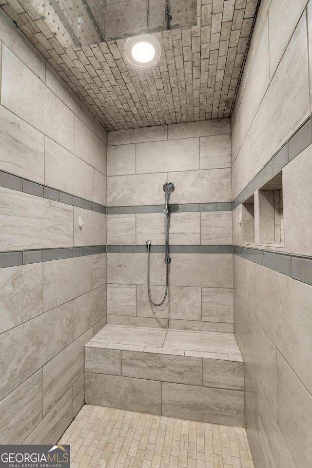 bathroom with a tile shower