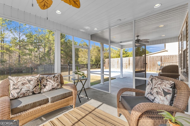 sunroom featuring a ceiling fan