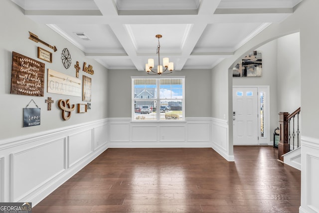 dining area with dark wood-style floors, arched walkways, visible vents, a chandelier, and beamed ceiling