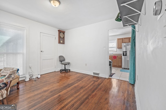 interior space featuring light wood-type flooring, visible vents, and baseboards