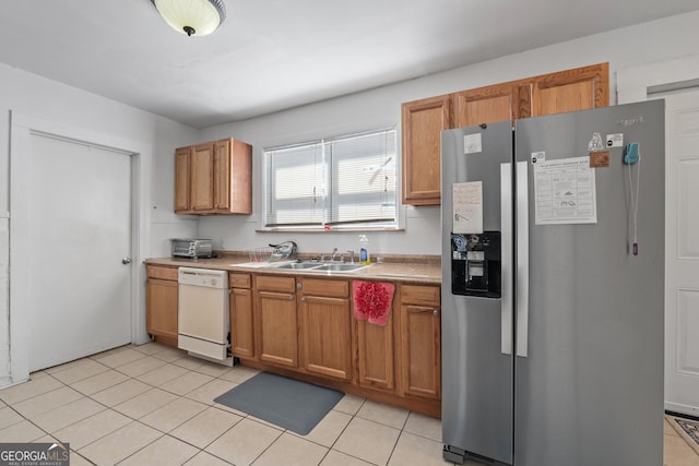 kitchen with dishwasher, brown cabinets, stainless steel refrigerator with ice dispenser, a sink, and light tile patterned flooring