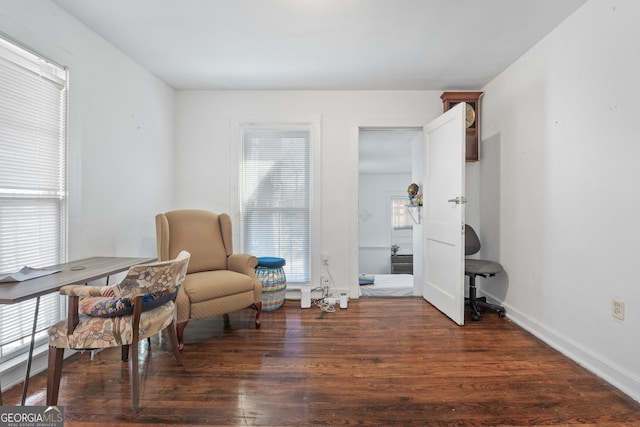 living area featuring baseboards and wood finished floors