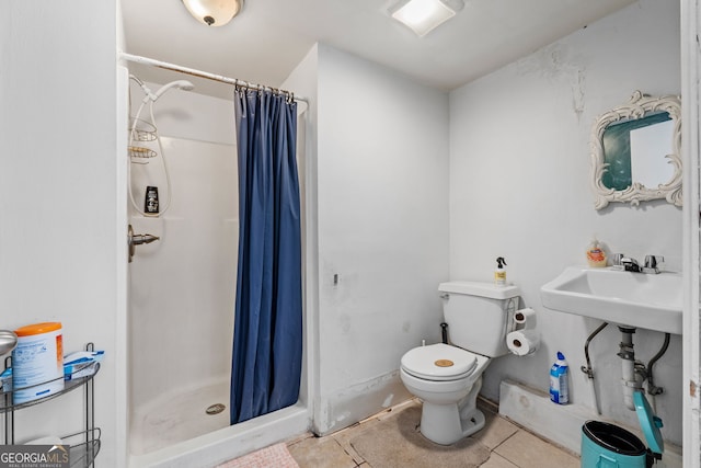 bathroom with toilet, a stall shower, a sink, and tile patterned floors