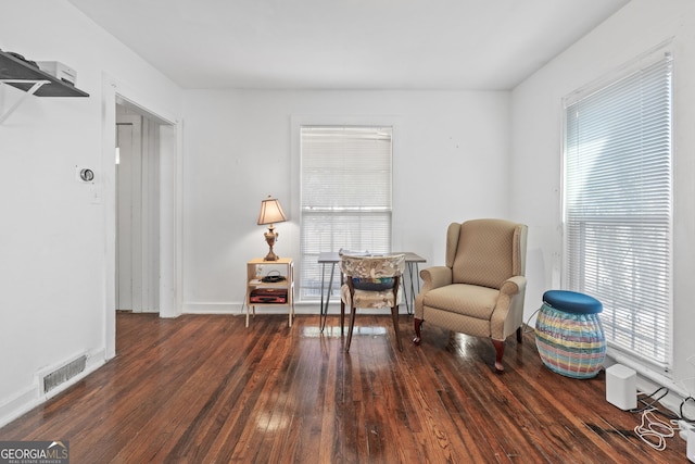 sitting room featuring hardwood / wood-style flooring, baseboards, and visible vents