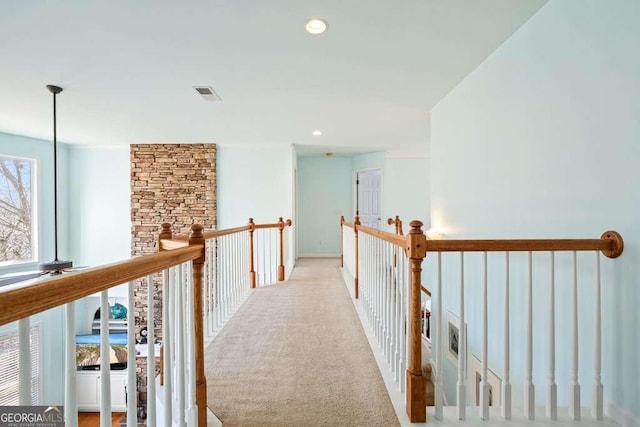 hallway with carpet, visible vents, and recessed lighting