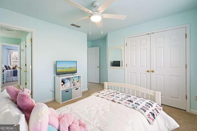 bedroom featuring baseboards, visible vents, light colored carpet, ceiling fan, and a closet