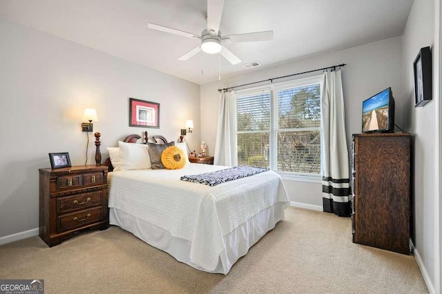 bedroom featuring light carpet, ceiling fan, visible vents, and baseboards