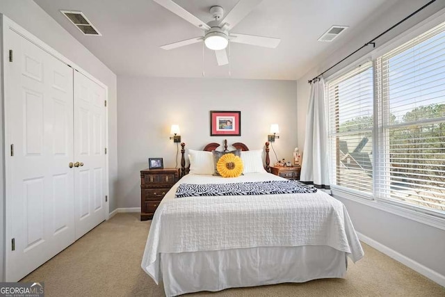 bedroom featuring light carpet, ceiling fan, visible vents, and baseboards