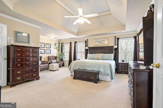 bedroom featuring a tray ceiling, crown molding, and carpet