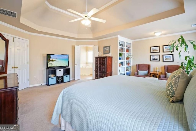 bedroom featuring ornamental molding, carpet floors, a tray ceiling, and visible vents