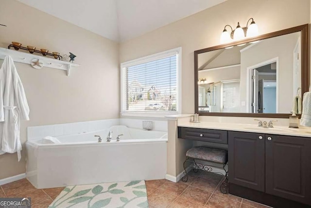 full bath with baseboards, lofted ceiling, tile patterned floors, a garden tub, and vanity