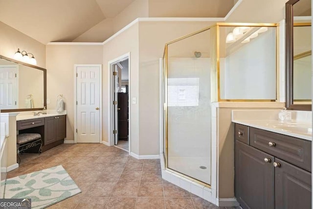 bathroom with lofted ceiling, two vanities, a stall shower, a sink, and tile patterned flooring