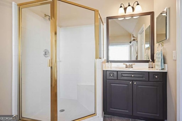 full bath with a stall shower and vanity