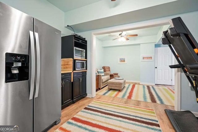 interior space with light wood finished floors, light countertops, appliances with stainless steel finishes, and a ceiling fan