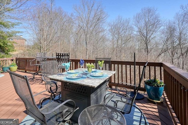 wooden deck featuring outdoor dining area