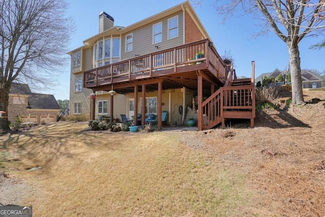 rear view of property with stairway, a chimney, and a wooden deck