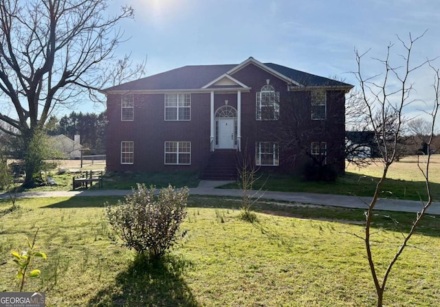 raised ranch with a front lawn