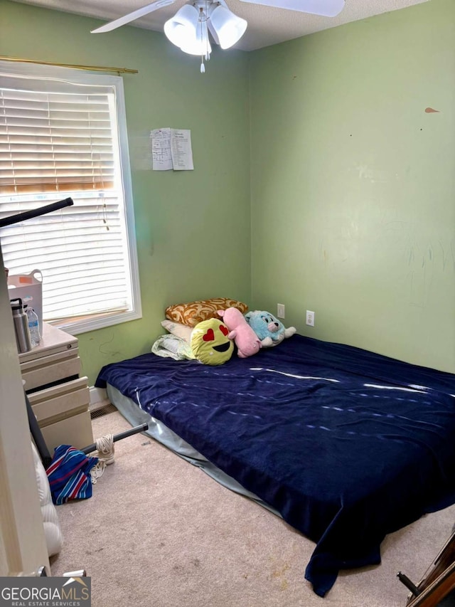 carpeted bedroom with ceiling fan