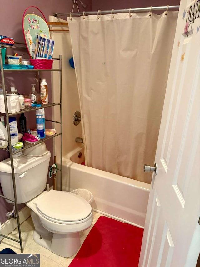 full bathroom with tile patterned flooring, shower / tub combo with curtain, and toilet