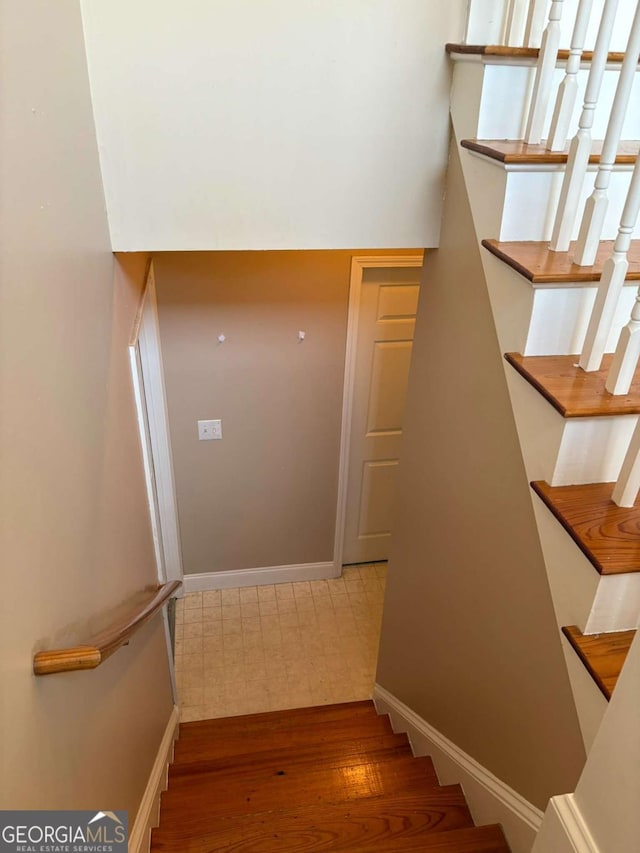 stairs with baseboards and wood finished floors