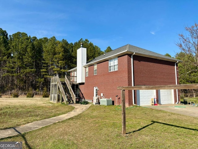 view of property exterior with a yard, stairs, and brick siding