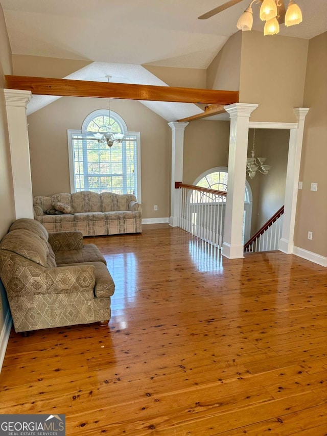 living room with hardwood / wood-style floors, plenty of natural light, and decorative columns