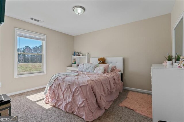 carpeted bedroom featuring visible vents and baseboards