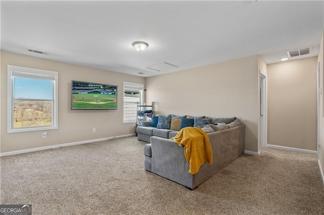 living area with baseboards, visible vents, and carpet flooring